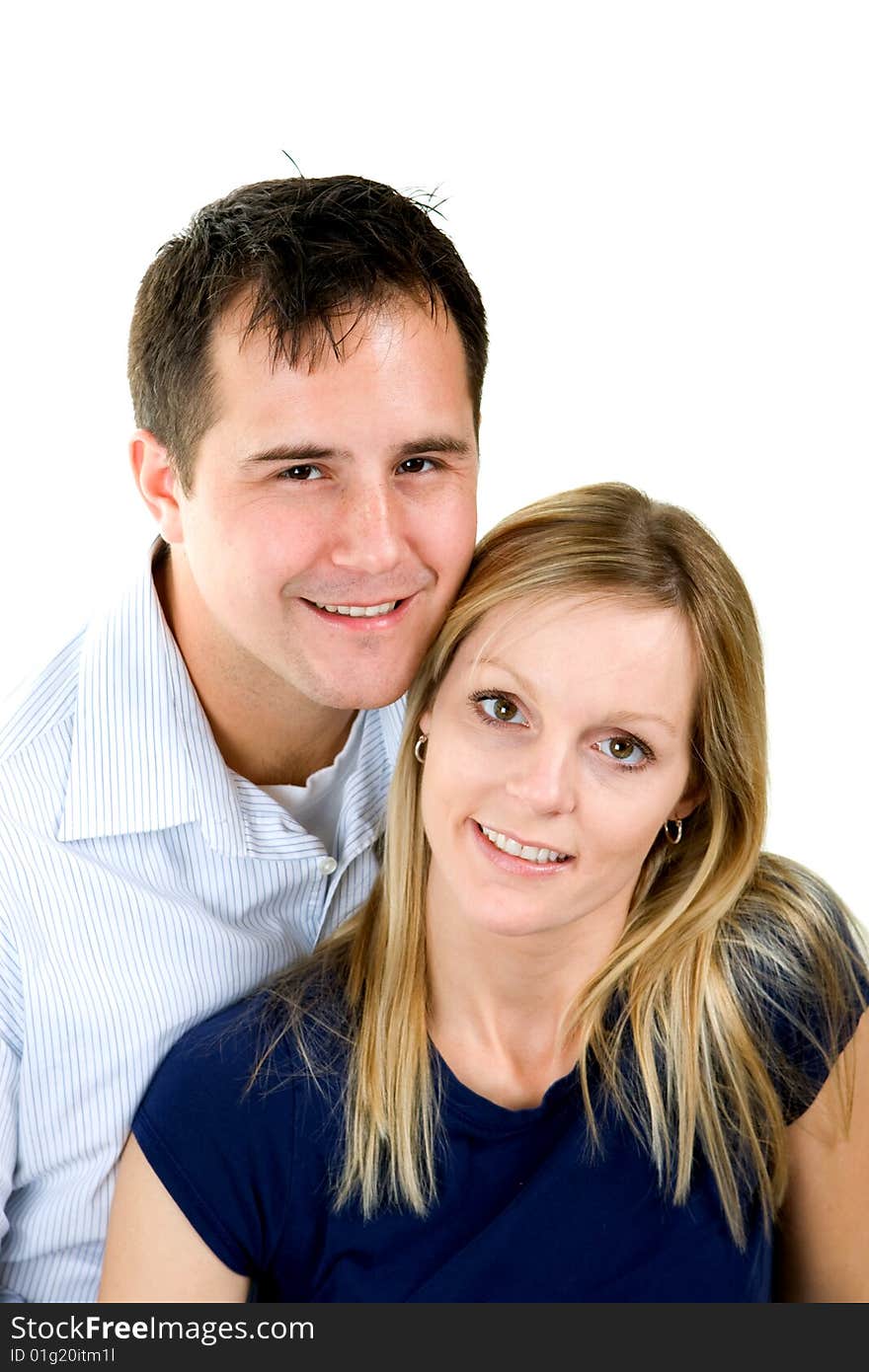 Attractive couple sitting together. Isolated on white background.