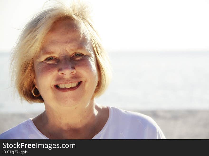 Photo of a happy senior on the beach. Photo of a happy senior on the beach