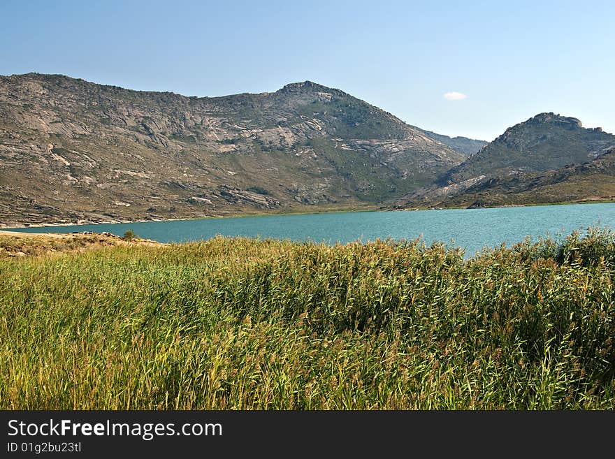 Lake and mountains landscape with blue sky