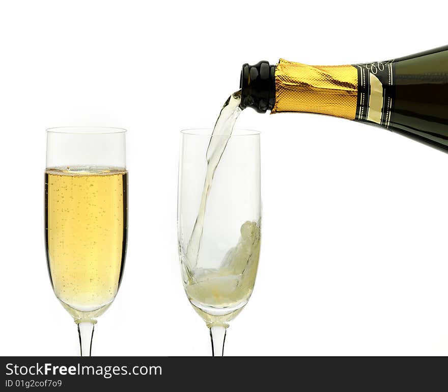 Champagne being poured into a flute, isolated on a white background. Champagne being poured into a flute, isolated on a white background.