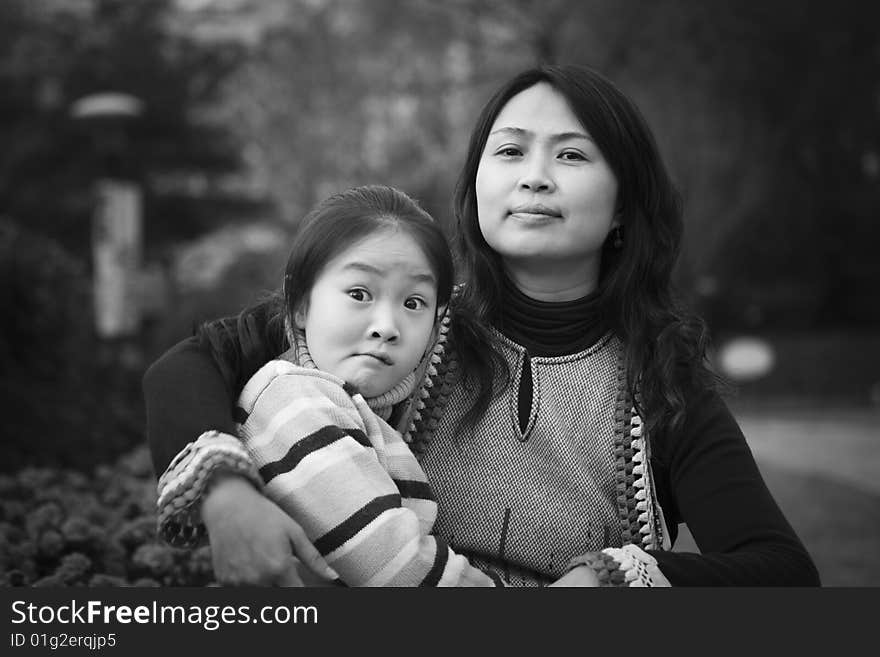 Mother and her 8 year old daughter having fun in a city park. Mother and her 8 year old daughter having fun in a city park.