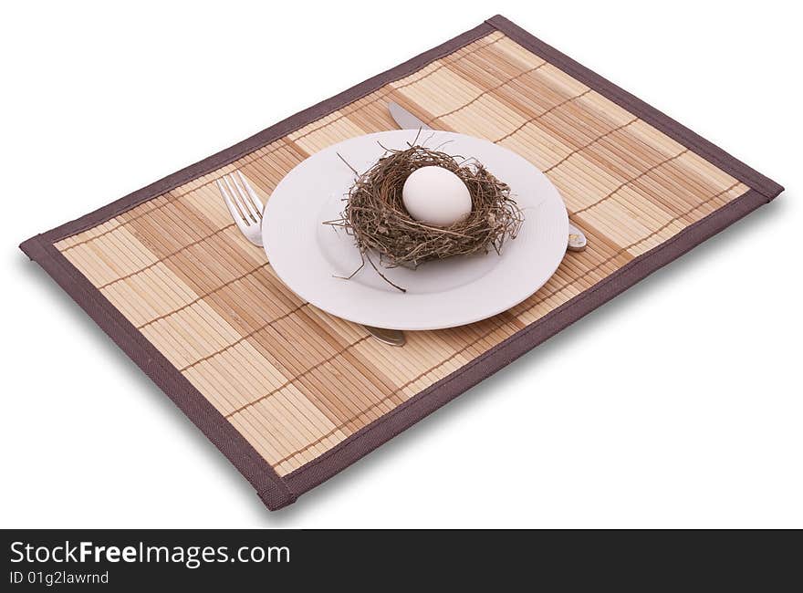 Egg in a nest served on a plate