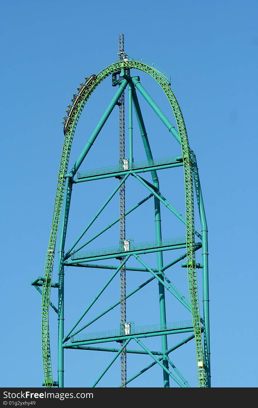 A metal roller coaster against blue sky