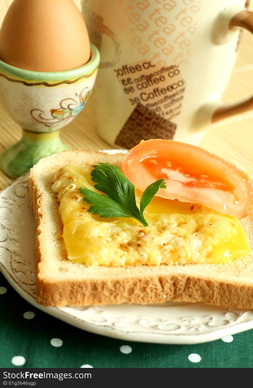 Breakfast, toast with fused cheese and slice of a tomato