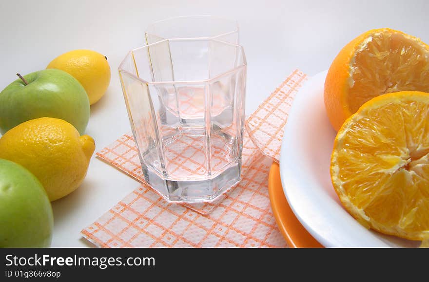 Fresh seasonal fruit, apples, bananas,  orange and glass fruit juice on reflective underground