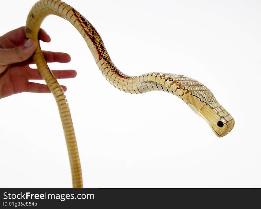 A wooden snake with a white background