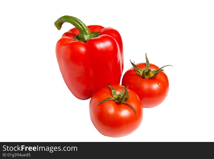 Raw fresh pepper and two tomatoes isolated on a white background. Raw fresh pepper and two tomatoes isolated on a white background.