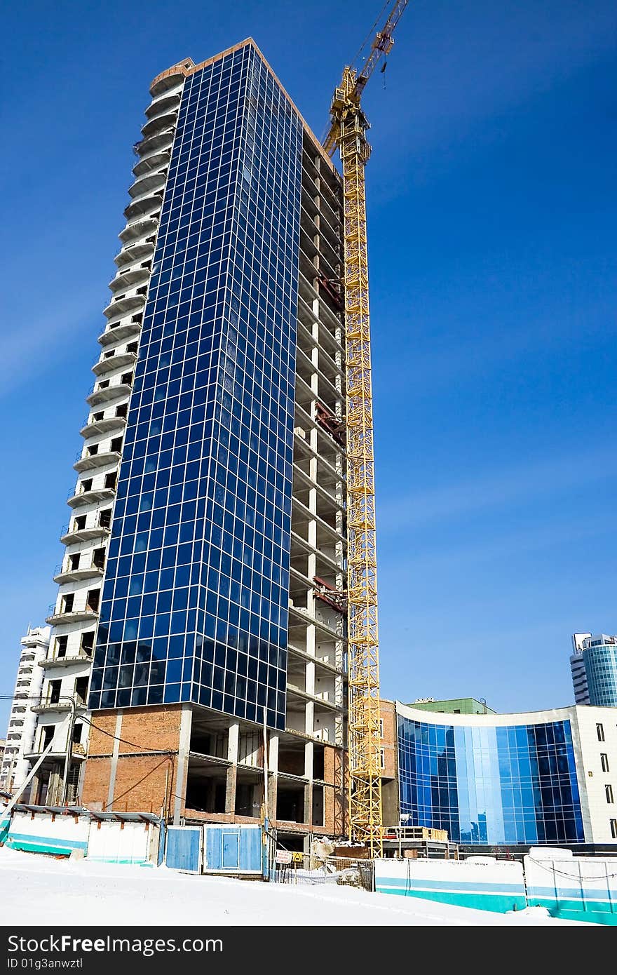 Construction of office building, on a background of blue sky