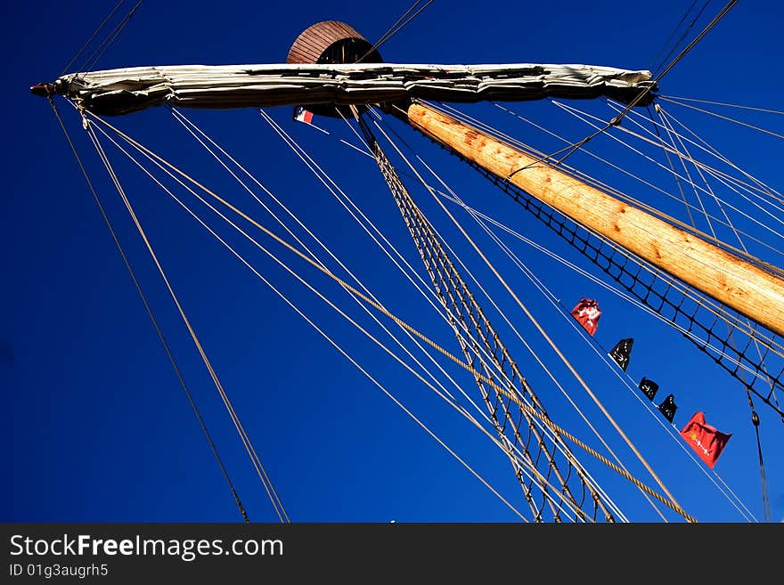 Mainmast, rigging, shroud lay and many more of a caravel in front of a blue sky. Mainmast, rigging, shroud lay and many more of a caravel in front of a blue sky