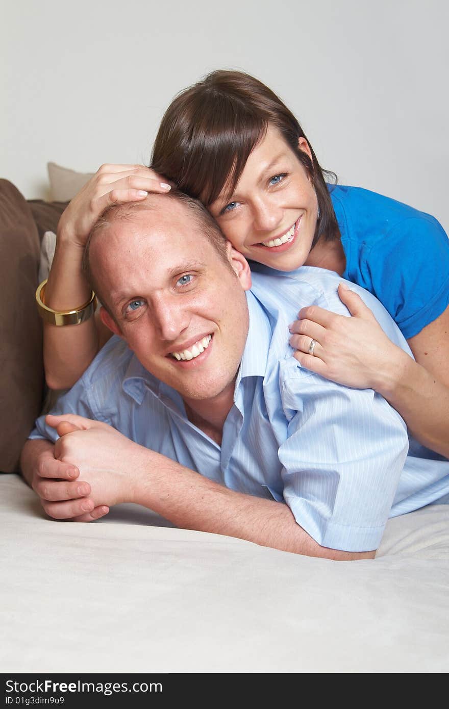 Beautiful young couple on a couch in their new appartment. Beautiful young couple on a couch in their new appartment.