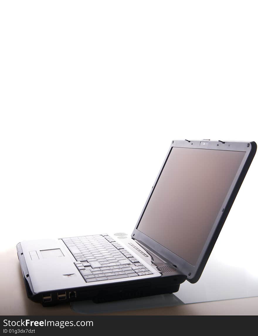 A laptop Computer on a table with white background. A laptop Computer on a table with white background.