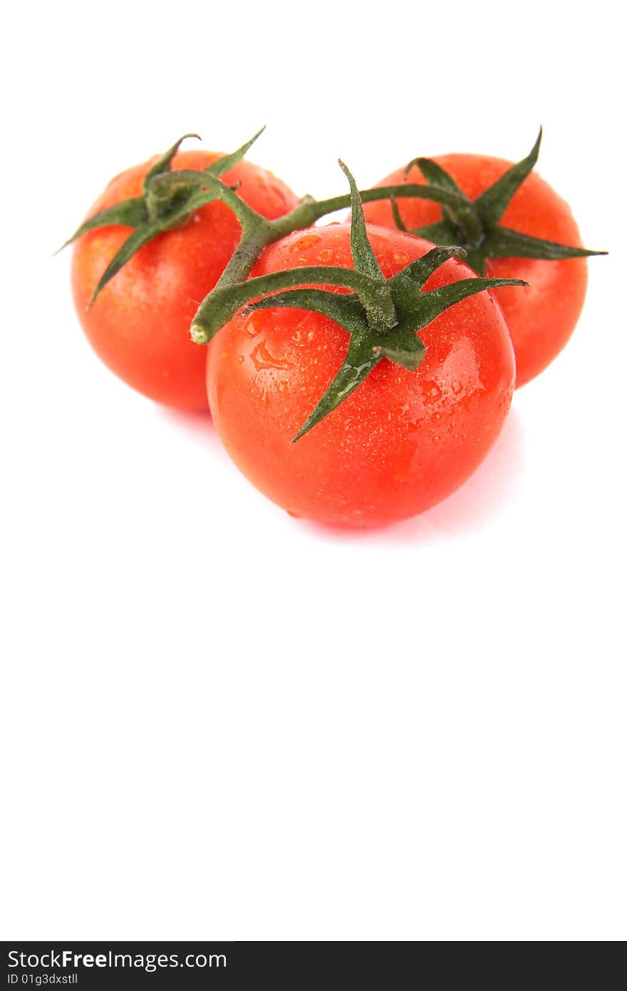 Macroshot of a bunch of tomatoes with drops of water. Isolated over white background. Lot of copyspace. Macroshot of a bunch of tomatoes with drops of water. Isolated over white background. Lot of copyspace.