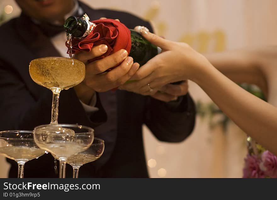 Close up of champagne pouring at wedding dinner reception