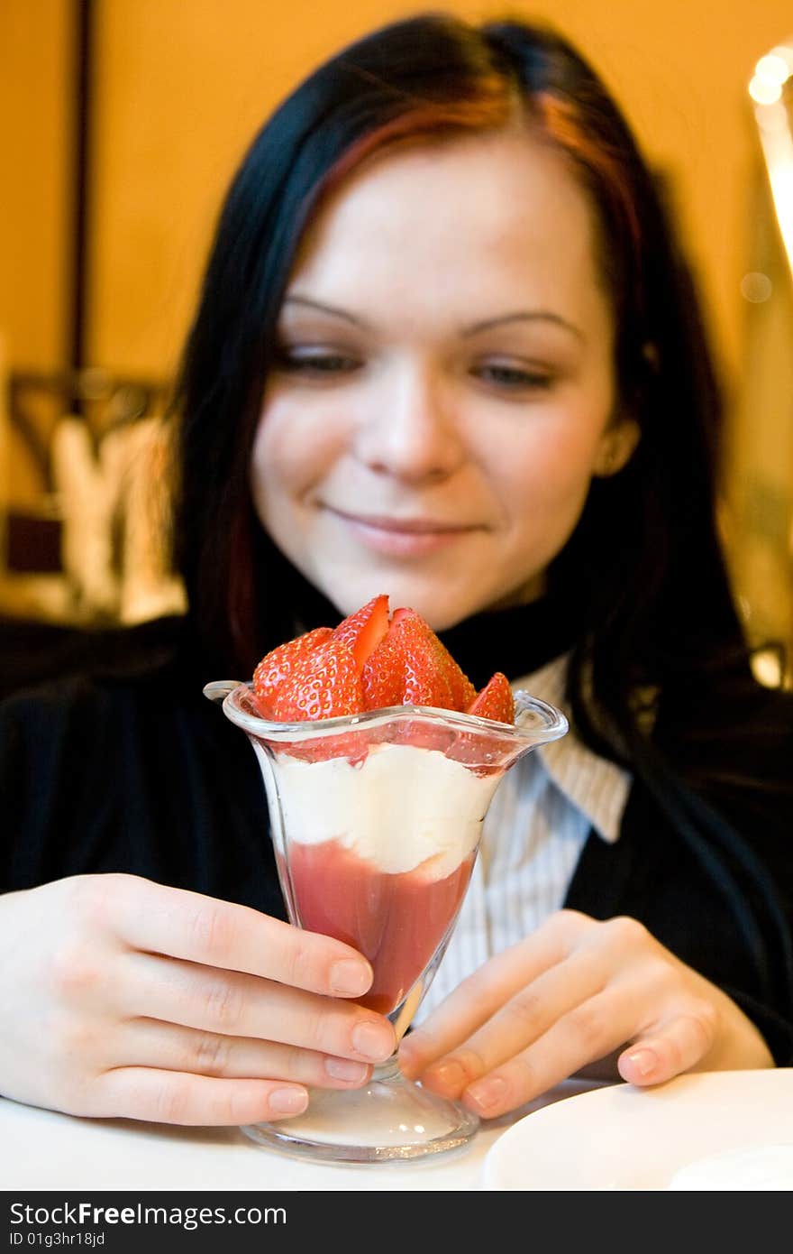 Dessert from a juicy red strawberry in a glass glass