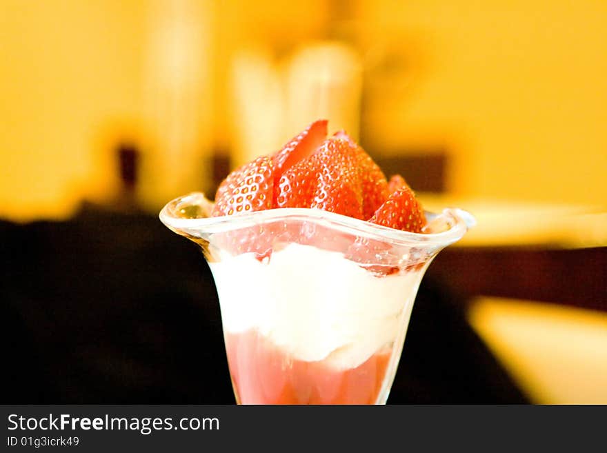 Dessert from a juicy red strawberry in a glass glass