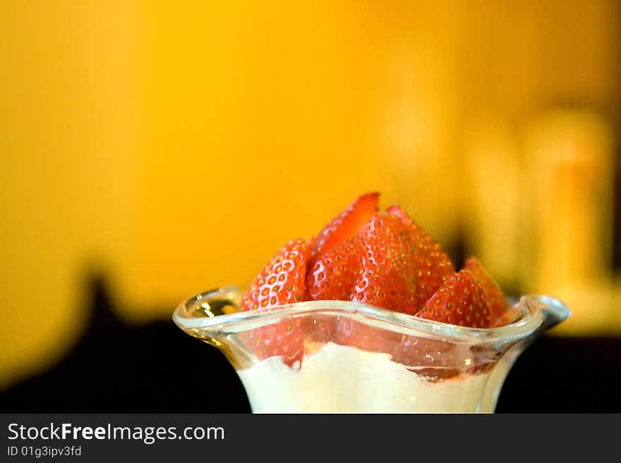 Dessert from a juicy red strawberry in a glass glass