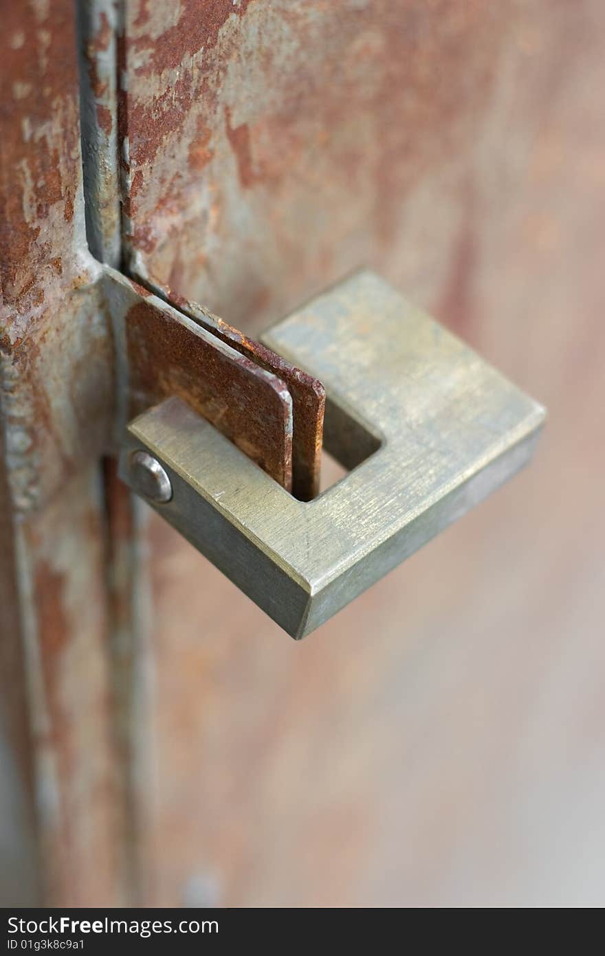 Padlock on old rusty door