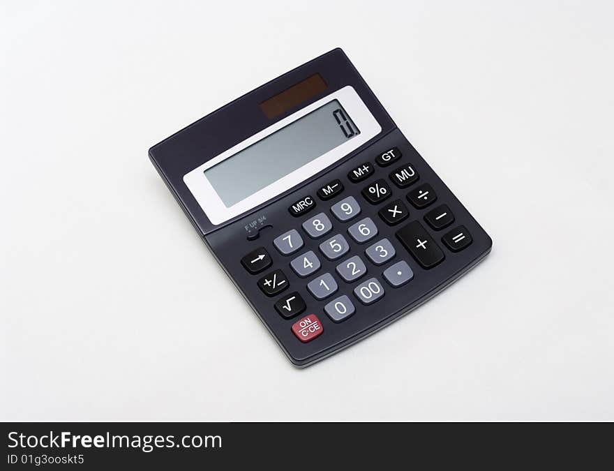 An electronic calculator on grey. An electronic calculator on grey