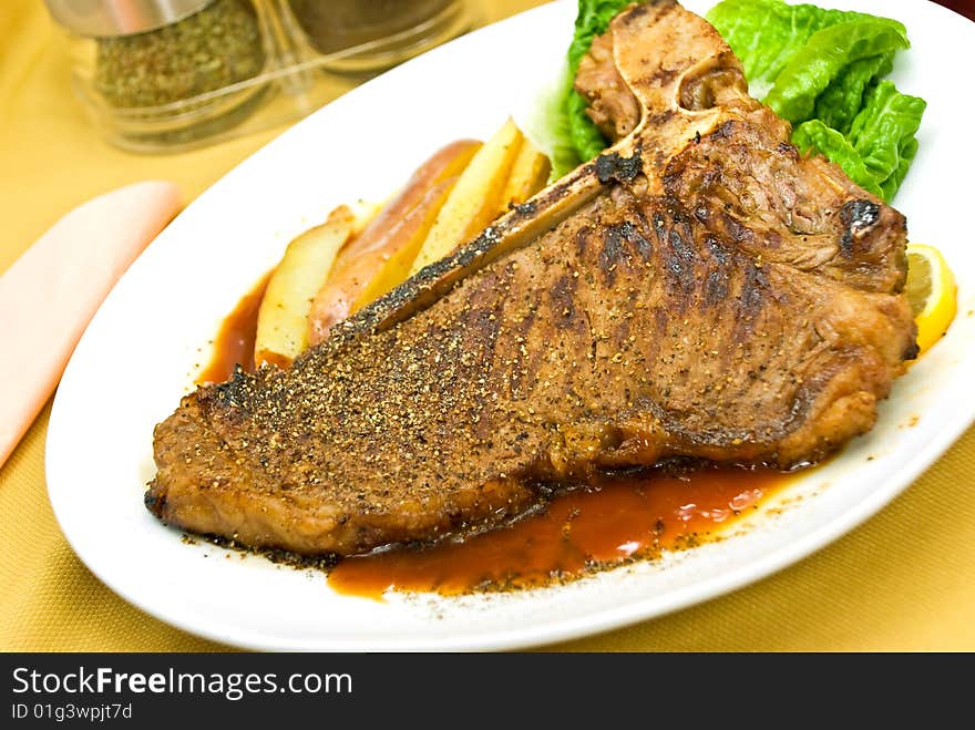 T - Bone Steak with fresh Salad and red Potatoes