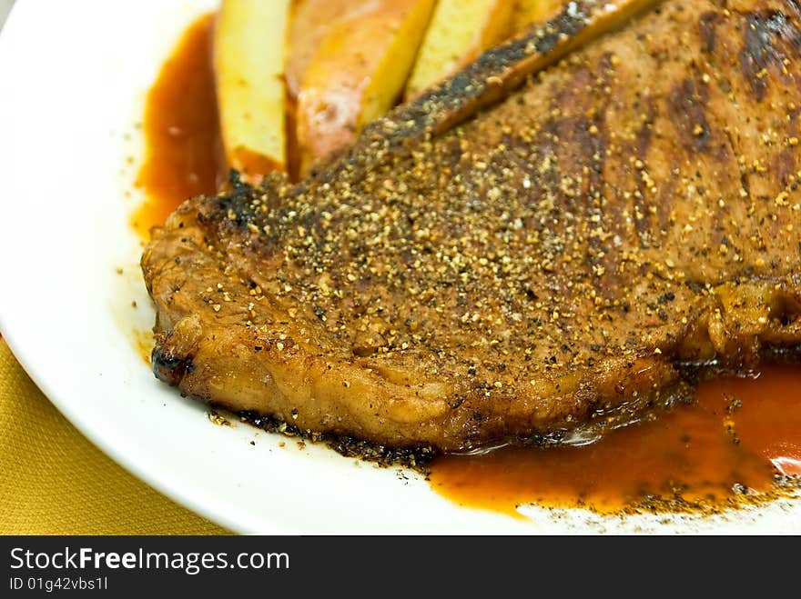 T - Bone Steak with fresh Salad and red Potatoes.