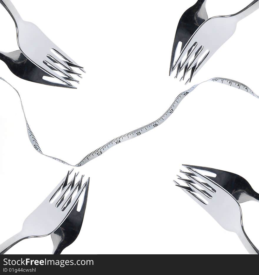 Multiple forks an measuring tape over white background