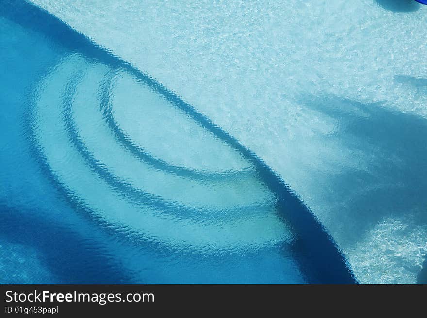 A cool blue pool gets shade from a nearby palm tree in the Gulf of Mexico. A cool blue pool gets shade from a nearby palm tree in the Gulf of Mexico.