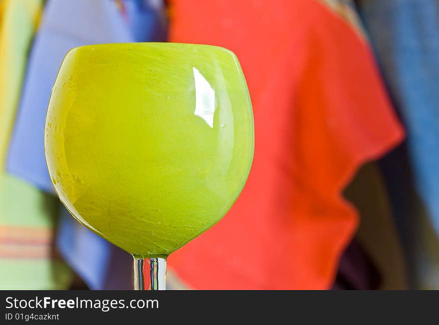 A margarita glass with a brightly colored fabric background. A margarita glass with a brightly colored fabric background.