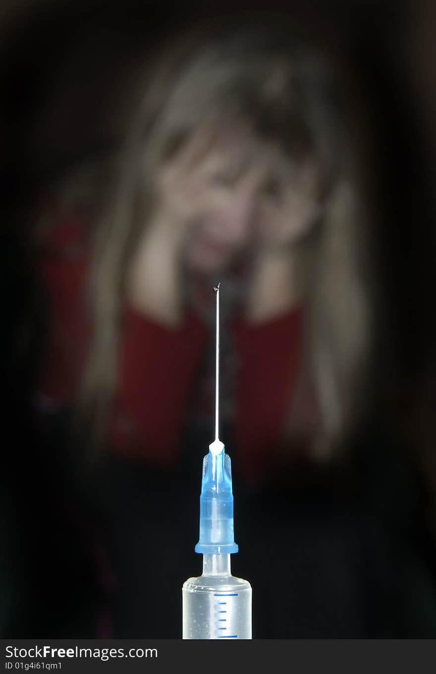 Syringe and outlines of the scared child on a black background. Syringe and outlines of the scared child on a black background