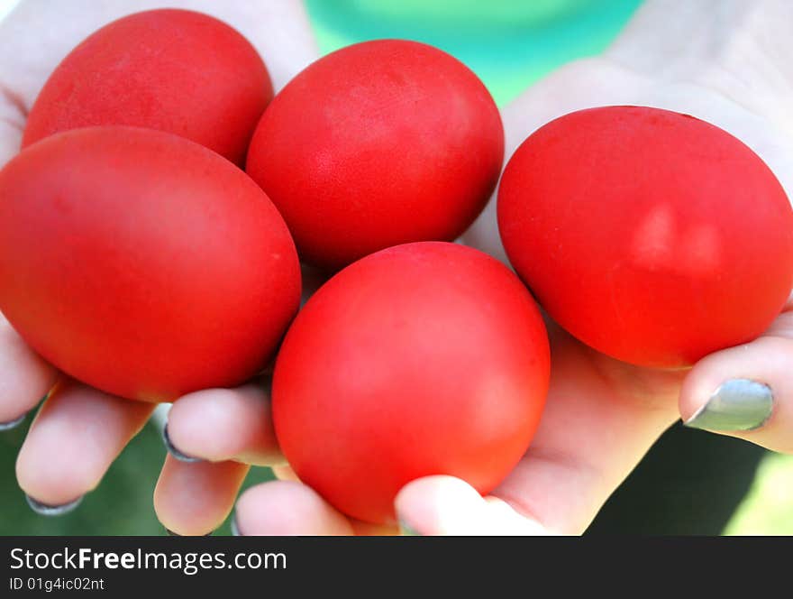 Easter red eggs on the hand.