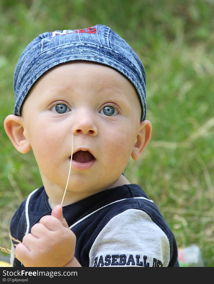 The little boy works as photomodel on a meadow