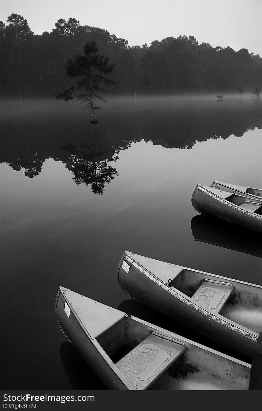 Canoes wait for riders at sunrise on on the Mountain Fork River. Canoes wait for riders at sunrise on on the Mountain Fork River.