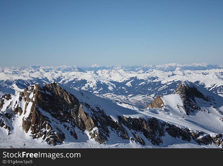 Austria. Mountains. The Alpes.Snow. The sun. Mountain tops.The bright dark blue sky.