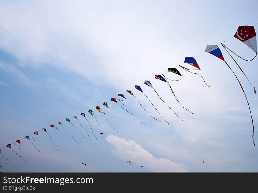 Waving asian countries national flag kites in action