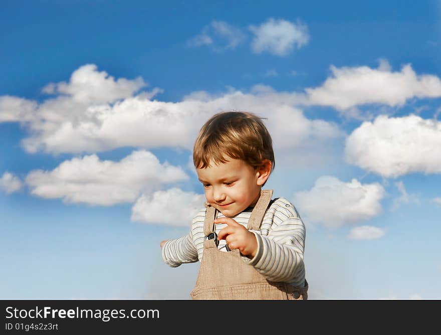 Happy boy running over sky background