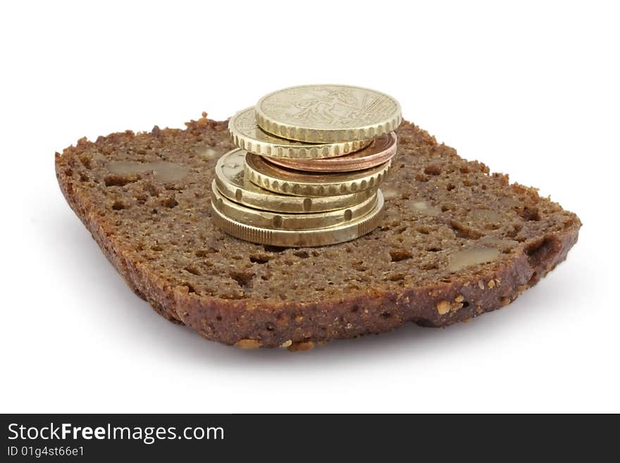 Pyramid from coins on a slice of bread. A white background.