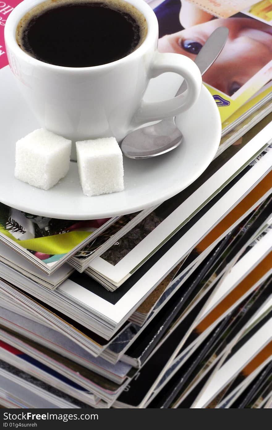 Cup Of Coffee On A Pile Of Magazines.