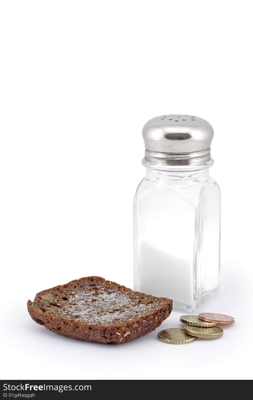 Bread with salt and coins. A white background.