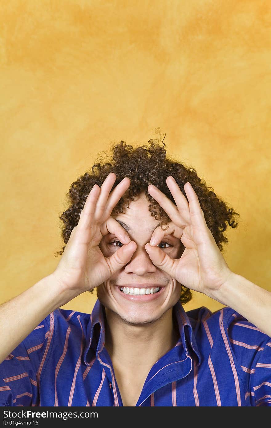 Man smiling with hand over eyes