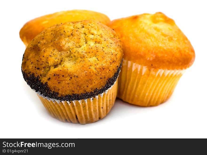 Three tasty muffins with poppies isolated on white background. Three tasty muffins with poppies isolated on white background