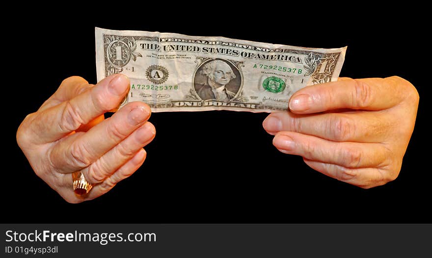 A elderly hand holds a money note. A elderly hand holds a money note