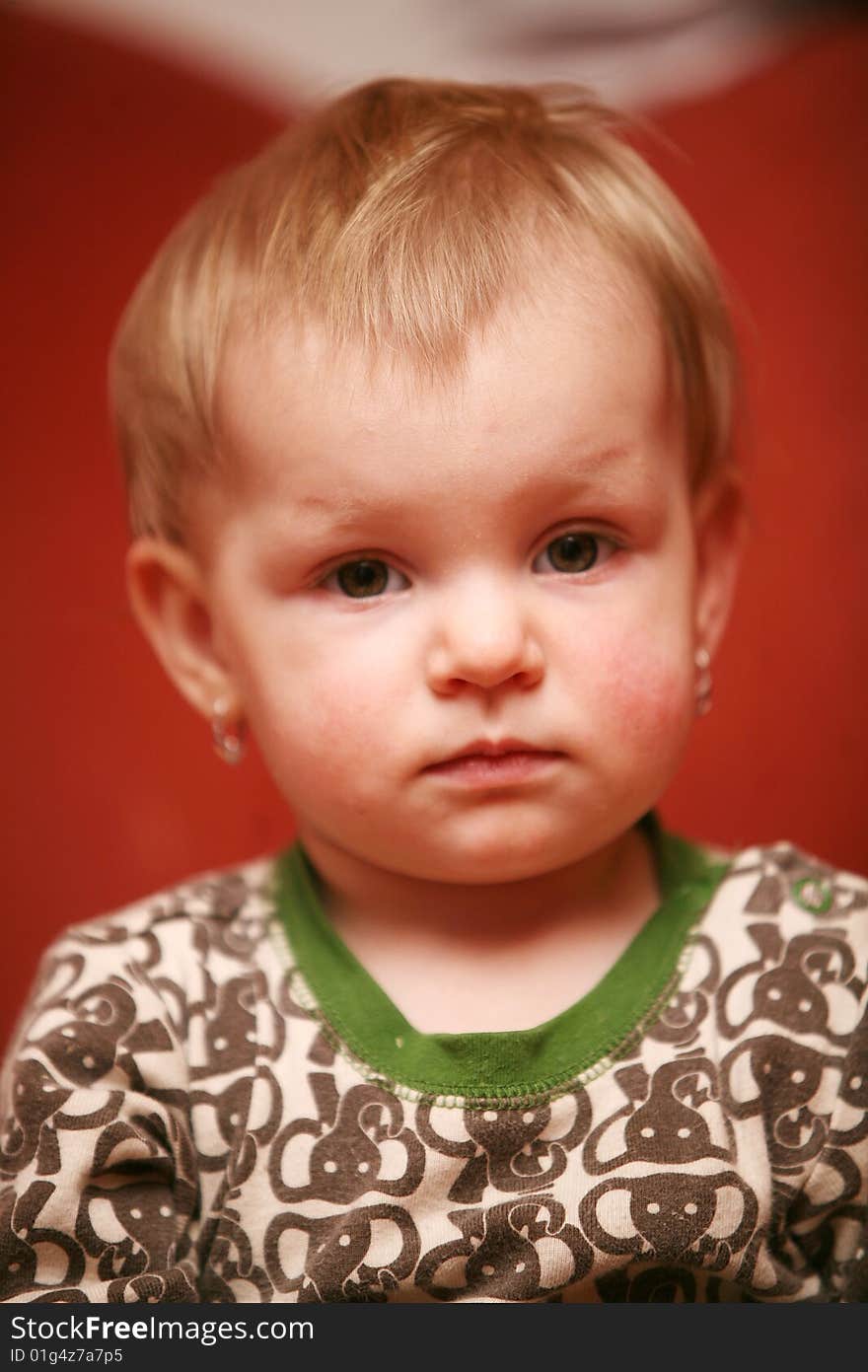 Small baby girl looks into camera