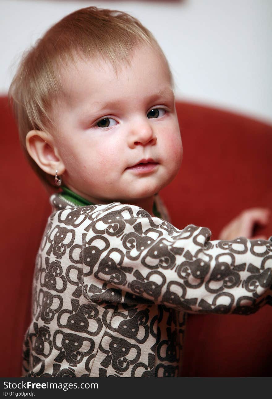 Small baby girl looks into camera