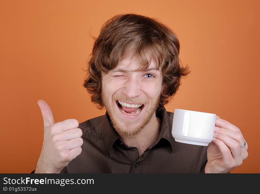 The emotional man with a cup in a hand and with copy space. The emotional man with a cup in a hand and with copy space