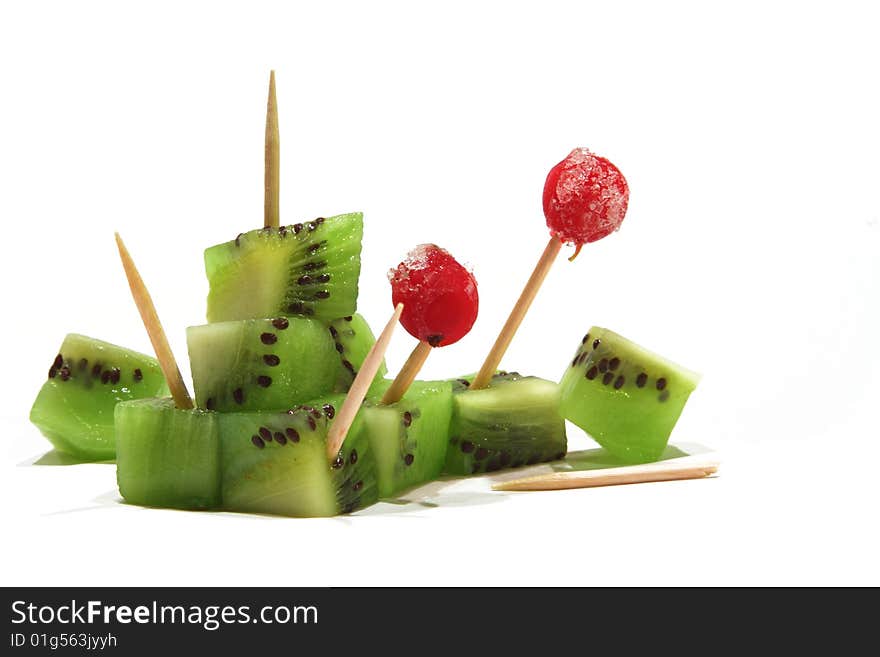 Kiwi cubes with toothpicks and redcurrants. Kiwi cubes with toothpicks and redcurrants.