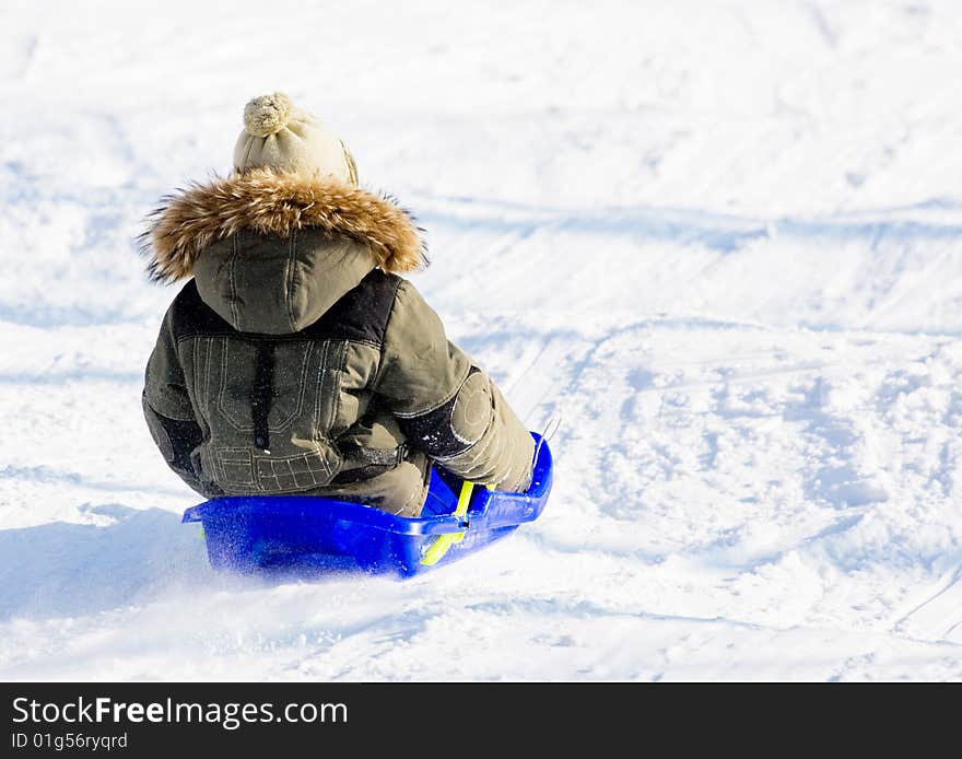 Child on a sled - winter holiday