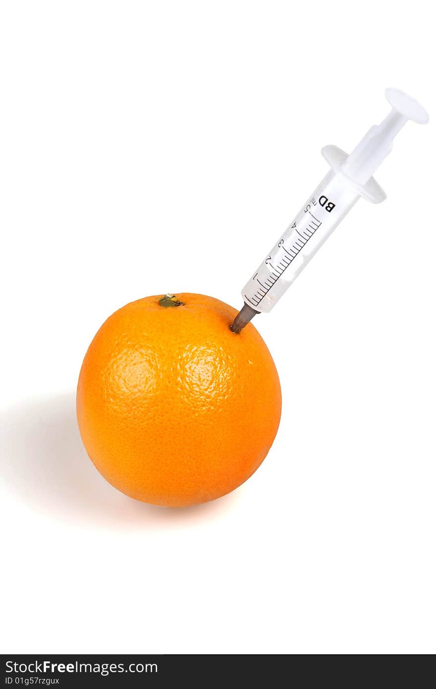 Syringes inserted into an orange isolated on white