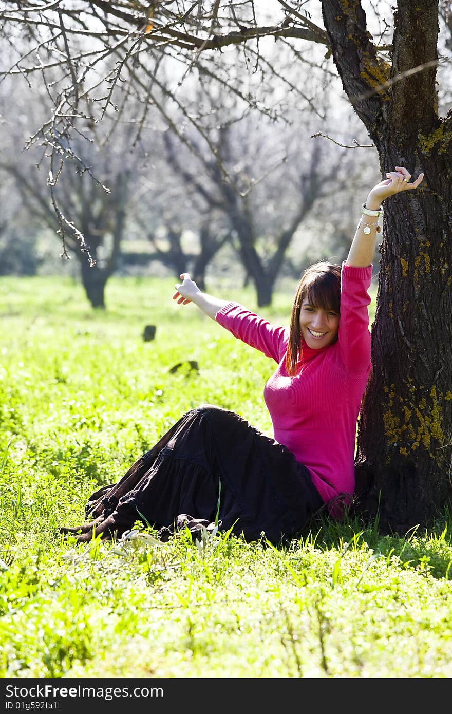 Young cheerful woman in a green forest. Young cheerful woman in a green forest.