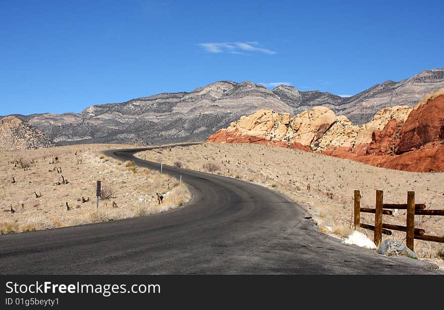 A Blacktop Highway Winding Through the Colorful Desert. A Blacktop Highway Winding Through the Colorful Desert