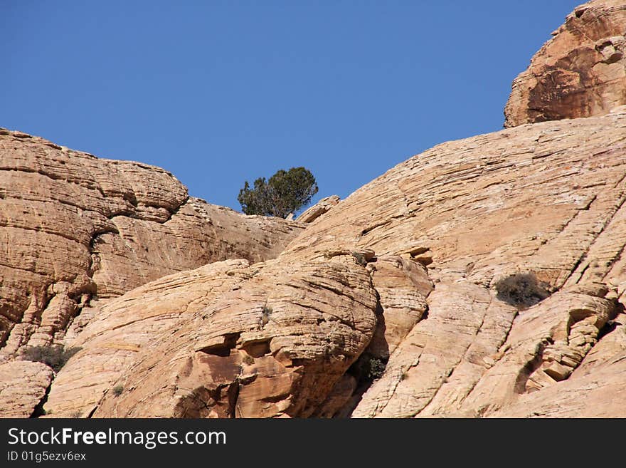 Brown and red desert landscape under a vivid blue sky