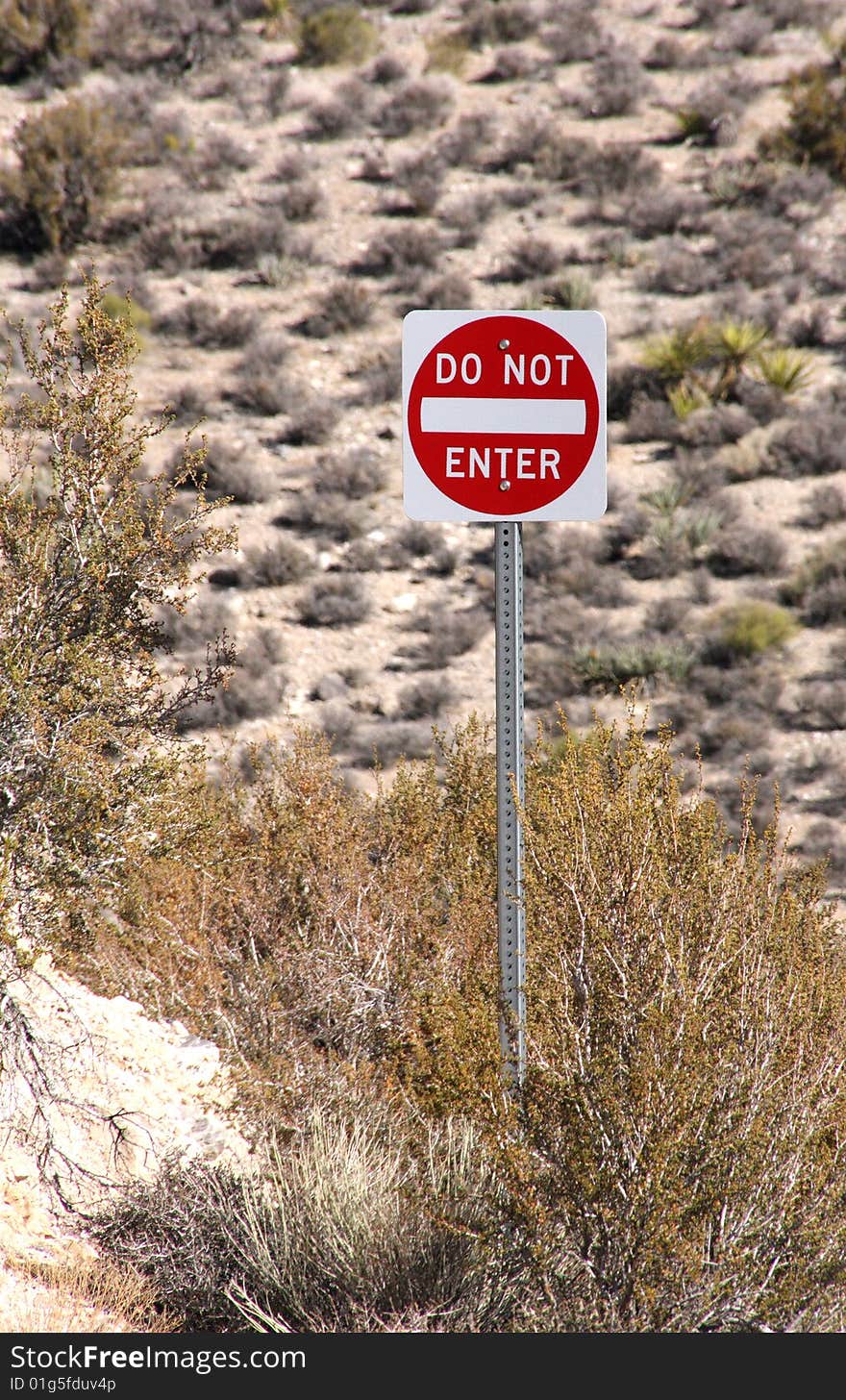 Do Not Enter sign surrounded by desert brush